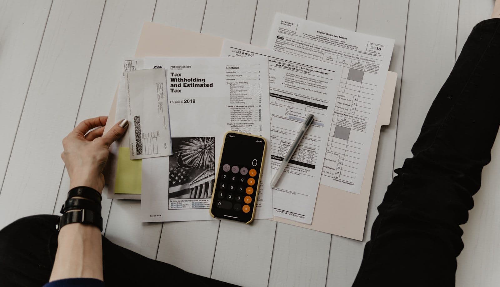 Financial documents and a calculator on a desk